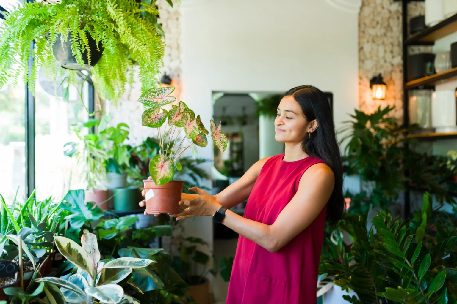Woman holding a plant in a retail store